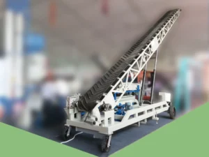 Truck loading conveyor with chevron belt